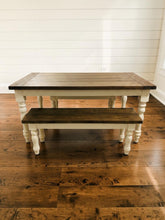 Load image into Gallery viewer, Farmhouse table and bench with dark stained wood tops and white turned legs against a white shiplap wall