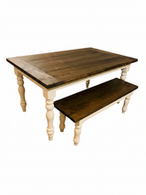 Load image into Gallery viewer, Angled studio view of five-foot farmhouse table and matching bench with dark walnut plank tops and white turned legs