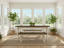 Load image into Gallery viewer, Dark walnut farmhouse table with two matching benches in a bright sunroom with large windows and potted plants
